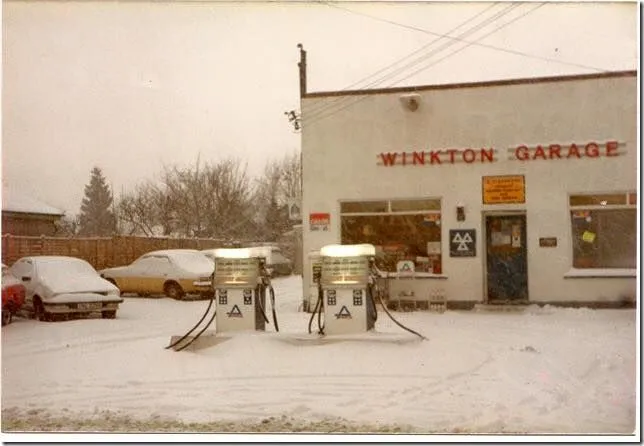 The old Winkton Garage building with its petrol pumps, in the snow