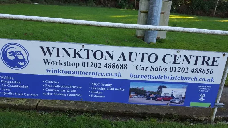 The Winkton Auto Centre banner on a fence