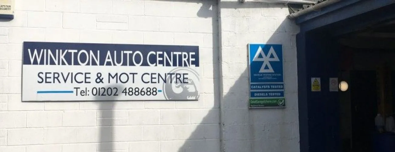 The Winkton Auto Centre sign on the workshop wall